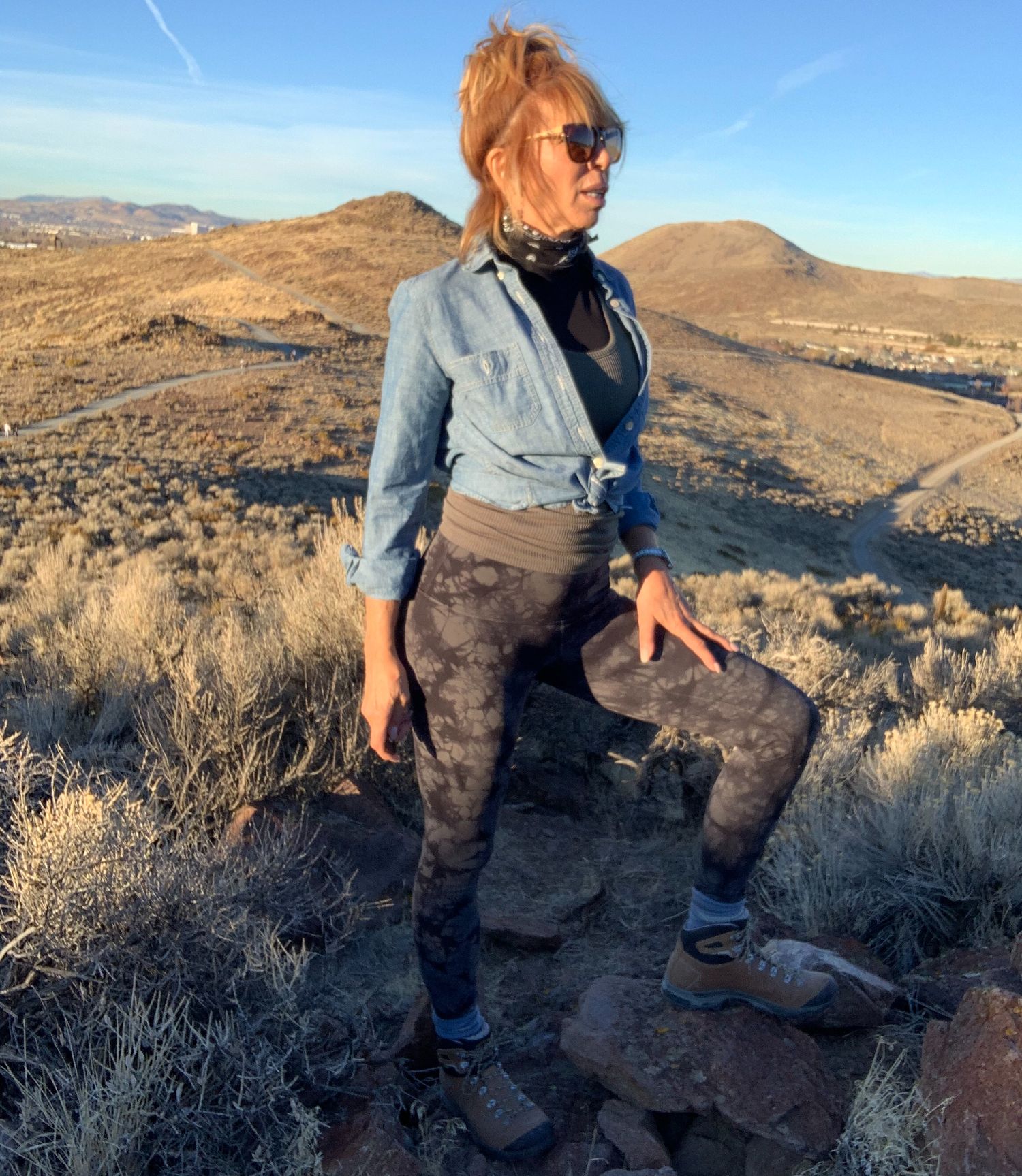 Shaaron standing on a desert hillside
