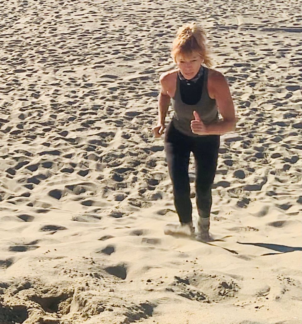 Shaaron walking across desert sand