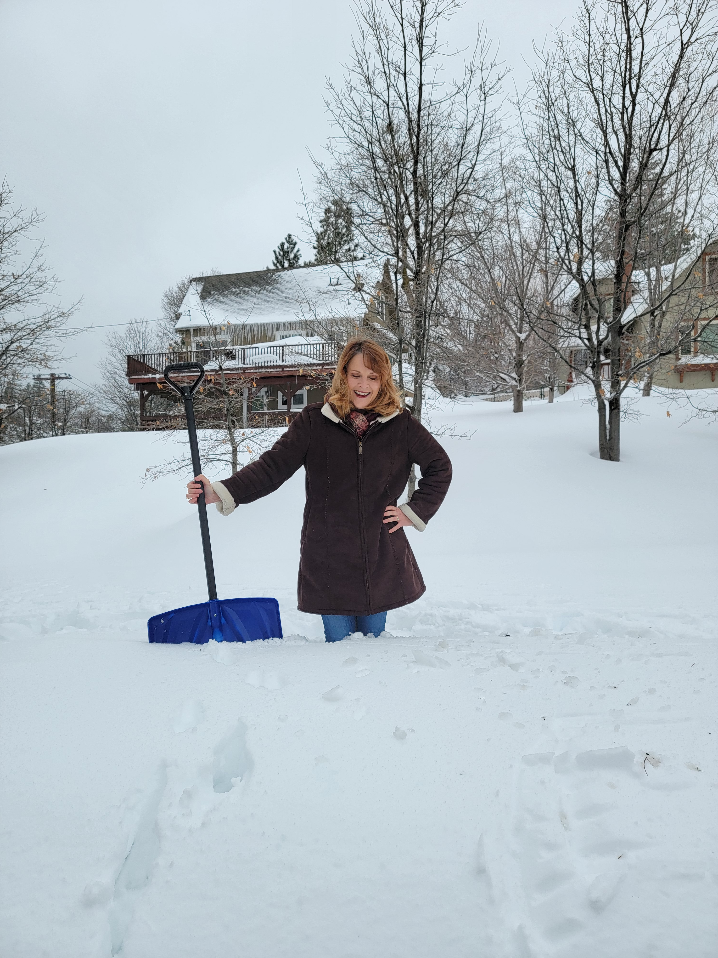 Theresa Grant, the best Realtor in Lake Arrowhead, showing off snow in front of her home in 2023, for the LA Times newspaper. 