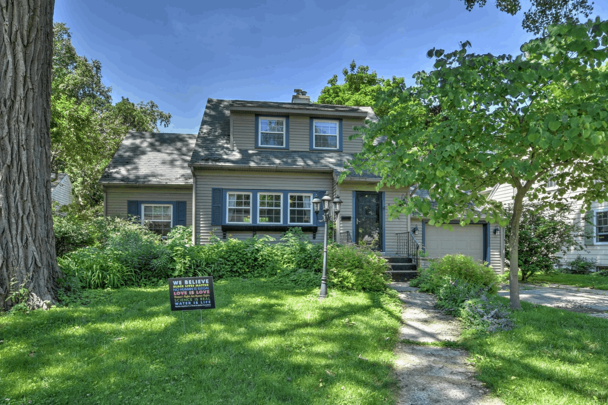 Photo of a suburban home with yard and trees, landscape orientation