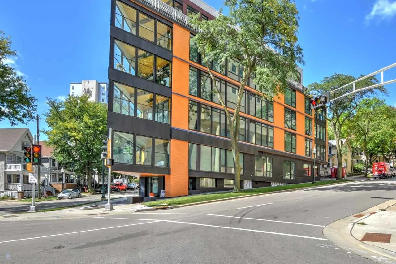 Photo of downtown condo building on a city street, landscape orientation
