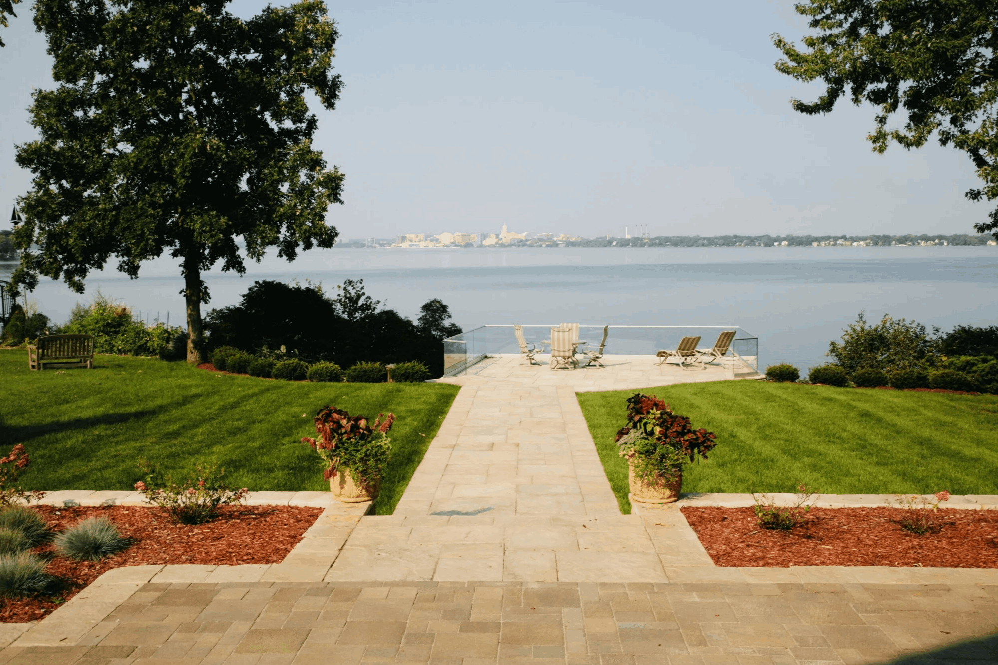 Photo of a waterfront home with walkway and landscaping, landscape orientation