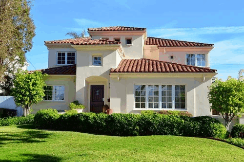 Photo of a Mediterranean style home with stucco and tile roof, landscape orientation