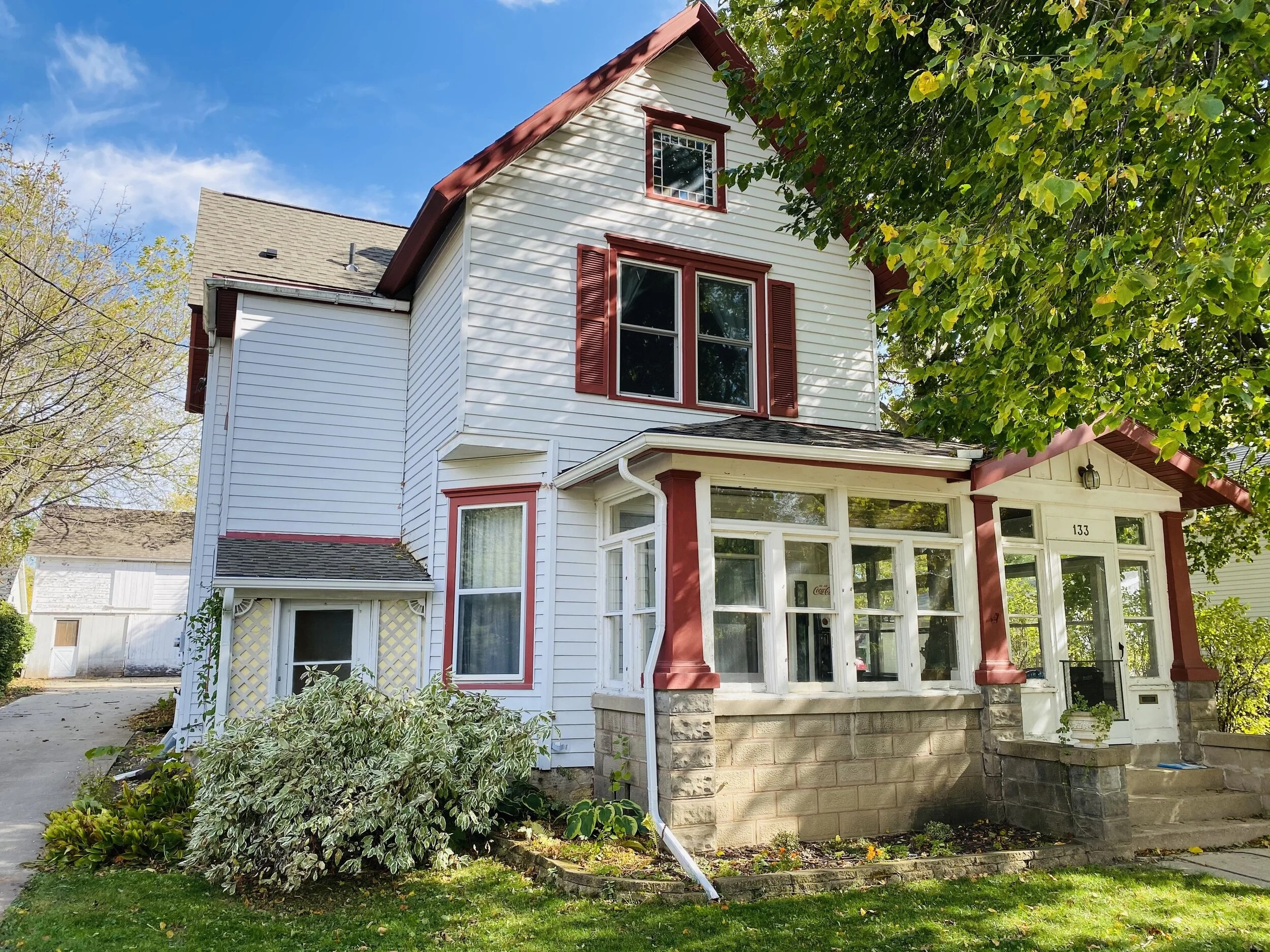 Photo of a charming older home with front porch and garden, landscape orientation