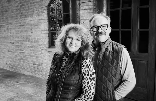 Les and Benita Peeler of Heartland Group Brokers, an Oklahoma City real estate team, on a porch
