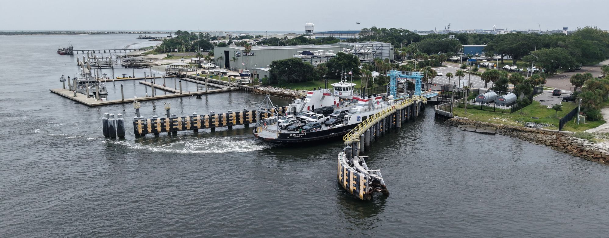 Aerial view of the Mayport waterfront in Jacksonville, Florida, showing marina docks, boat ramps and boats along the water.