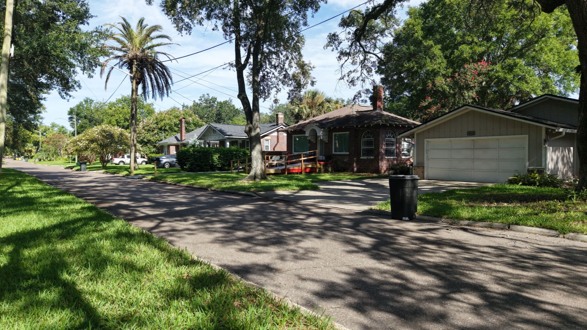 Tree-lined residential street with historic brick and bungalow-style homes in Murray Hill, Jacksonville, Florida.  Use this one for the overview block.
