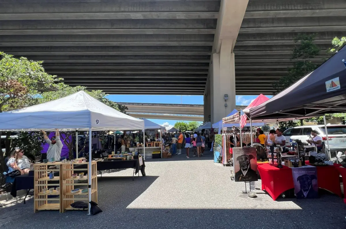 Local vendors beneath the Fuller Warren Bridge at Riverside Arts Market in Jacksonville