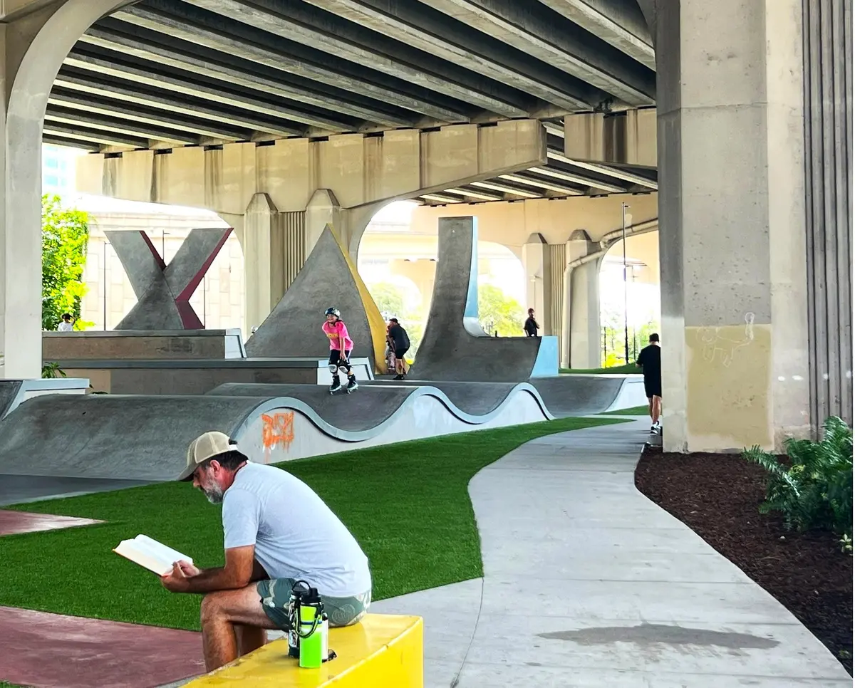 Skateboarder, rolloerblader and reader at the skate park near Riverside Park in Jacksonville Florida