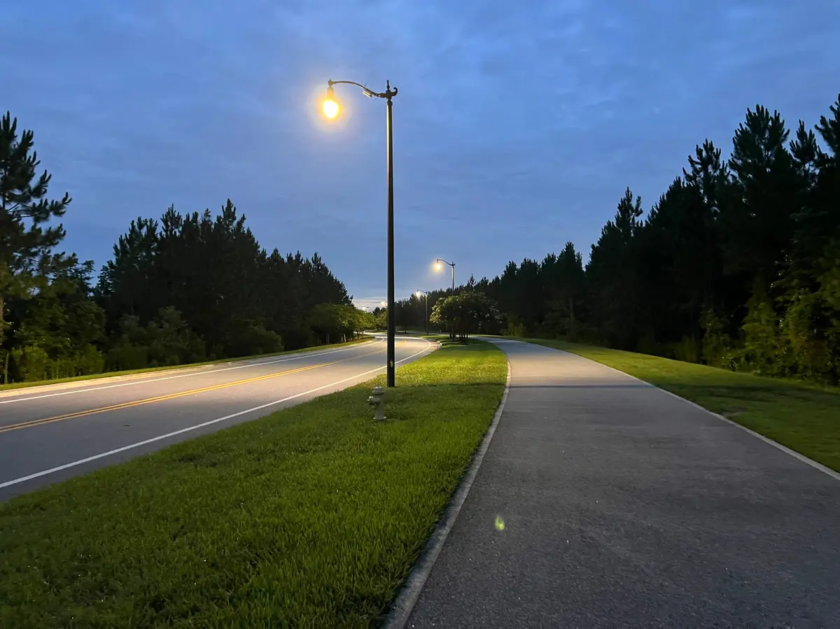 Lighted walking trail bordered by landscaped green space in eTown, Jacksonville.