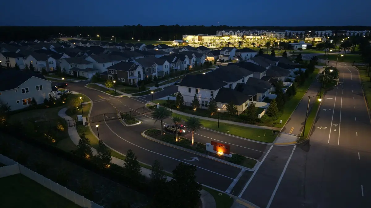 Illuminated homes and nearby shopping in eTown, Jacksonville, after sunset.