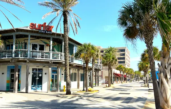 Restaurants and palm-lined streets in the Jacksonville Beach dining district, showcasing the area's walkable coastal atmosphere and local businesses.