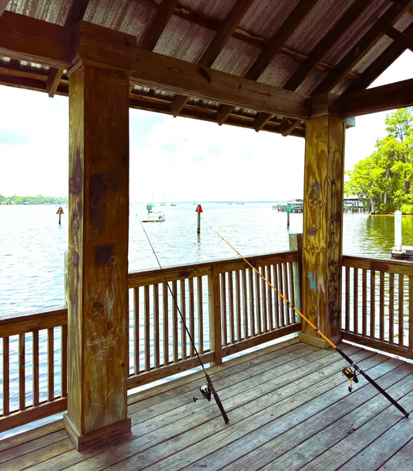Covered fishing pier overlooking the St. Johns River in Mandarin, Jacksonville, Florida, highlighting the area's relaxed waterfront lifestyle and recreational fishing.