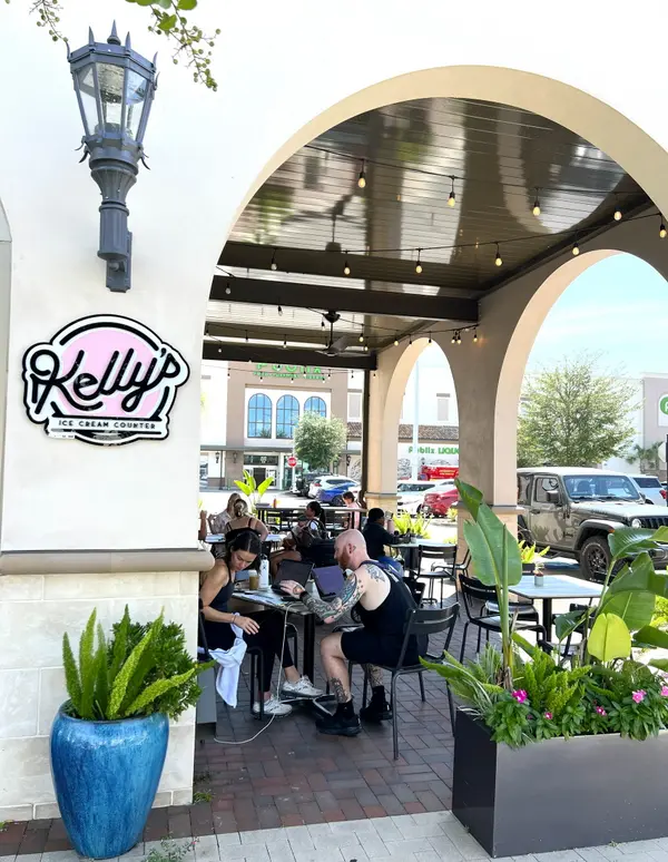 People enjoying coffee at a local café in San Marco Square, showcasing the neighborhood's walkable lifestyle and vibrant community atmosphere in Jacksonville, Florida.