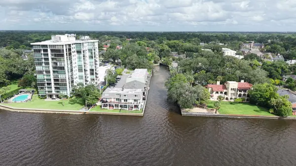 Aerial view of riverfront residences, condominiums and mature tree canopy in Avondale, Jacksonville, Florida.