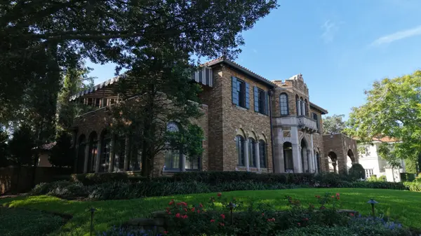Historic brick home beneath mature oak trees in Avondale, Jacksonville, Florida