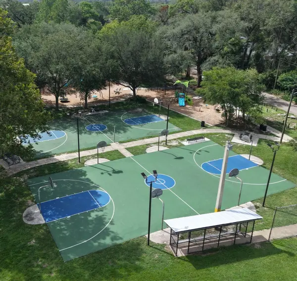 Aerial view of basketball courts and a playground at Fishweir Park in Avondale, Jacksonville, Florida.