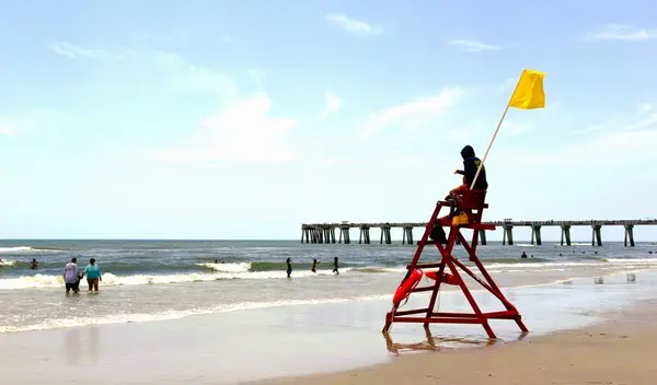 Jacksonville Beach with ocean, lifeguard stand and pier, a coastal destination near Seven Pines.