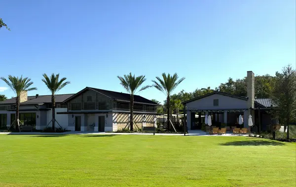 The Grove amenity and gathering area with landscaped lawn and palm trees in EverRange, Jacksonville, Florida.