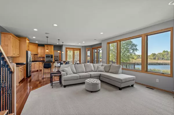 Interior photo of a beautiful open floor plan living room and kitchen with nature views in the backyard
