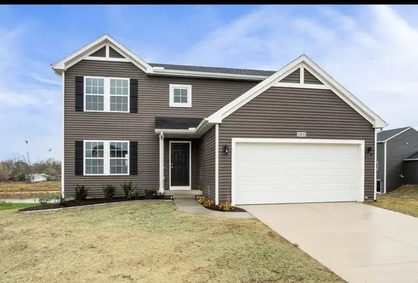 New construction two-story home with dark gray siding, white trim, black shutters, and an attached two-car garage.