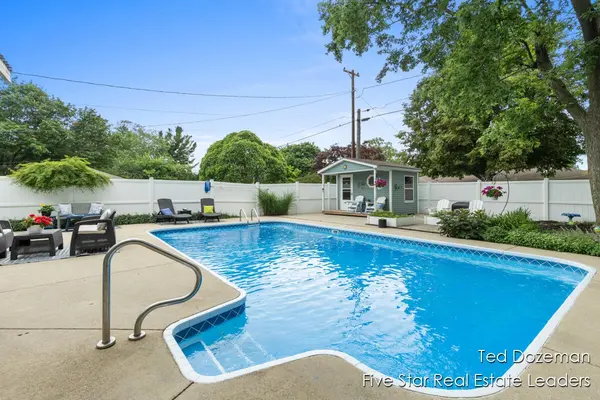 Beautiful backyard swimming pool with sparkling blue water, spacious patio, privacy fencing, and lush landscaping. 💙