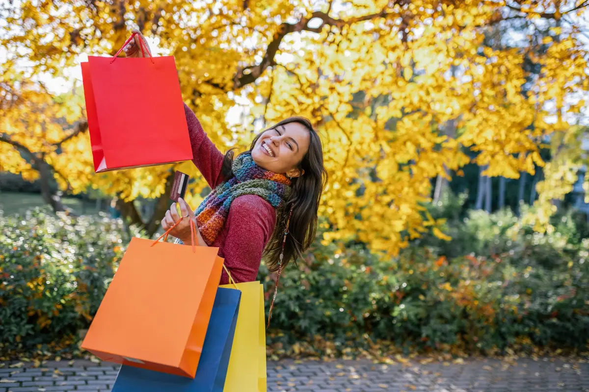 Woman with shopping bags in fall