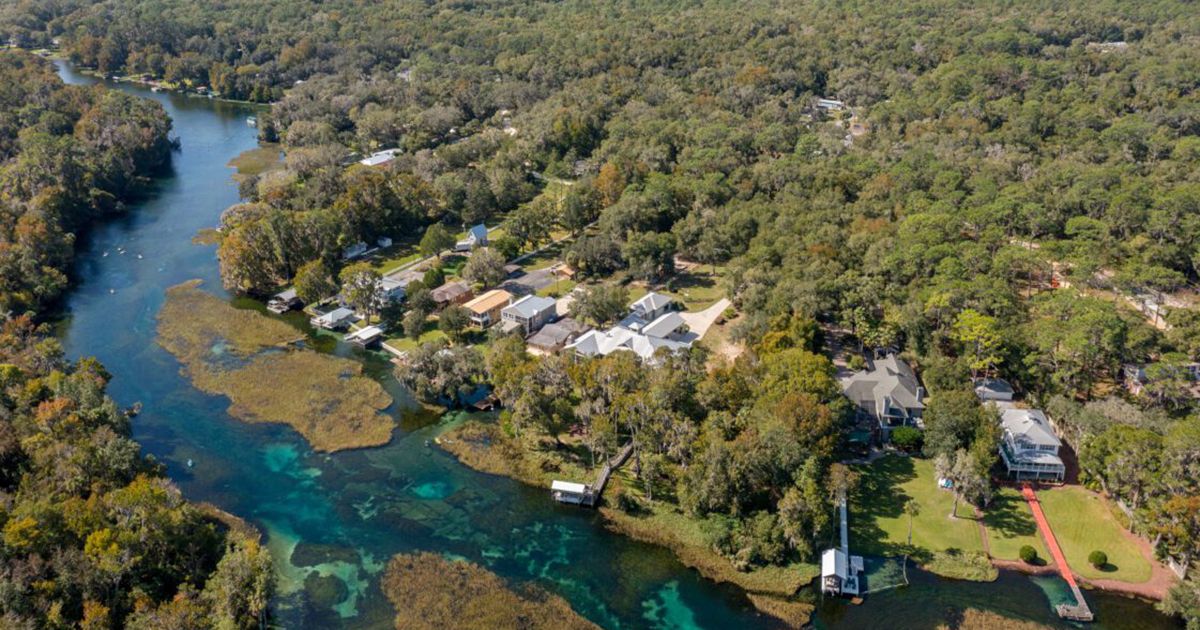 Aerial view of crystal clear Rainbow River with waterfront homes in Dunnellon Florida Marion County