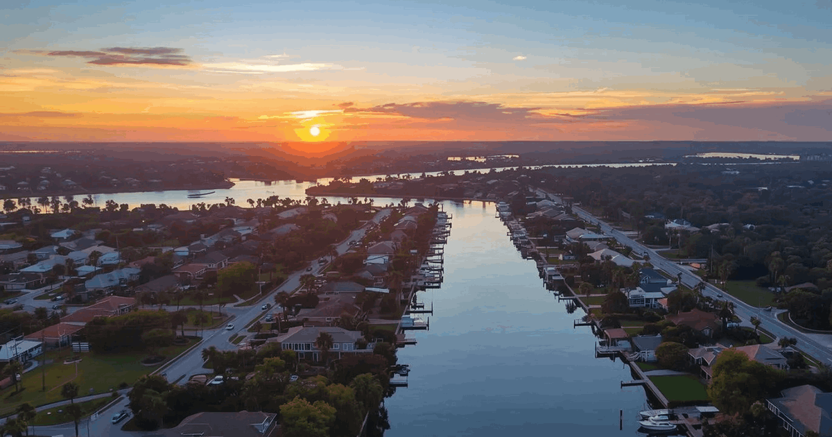 Aerial view of waterfront canal homes with boat docks at sunset in Riverview Florida Hillsborough County