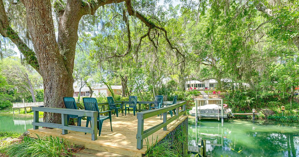 Citrus Wooden deck overlooking a spring-fed canal with boat dock and oak trees in Citrus Springs Florida Citrus County