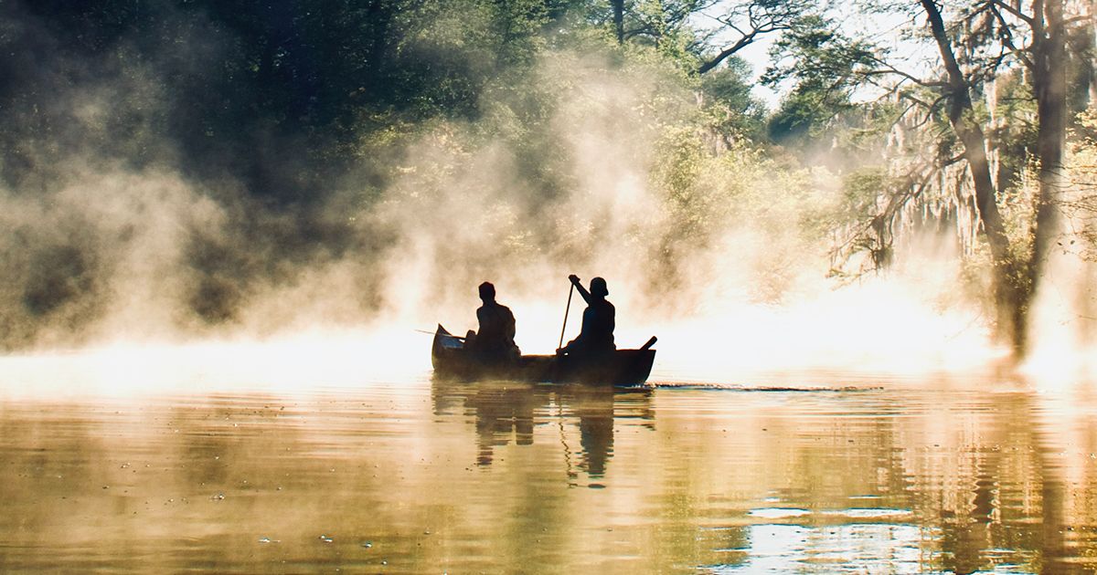 Canoe paddling through morning mist on the Peace River near Zolfo Springs Florida in Hardee County