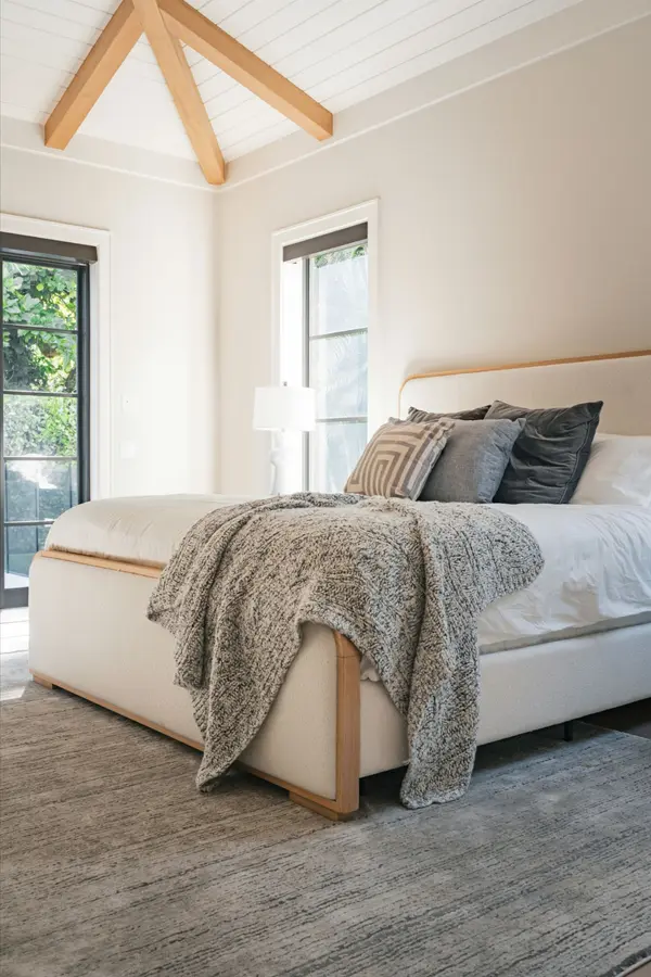 light-colored-bedroom-with-bed-and-wood-paneling