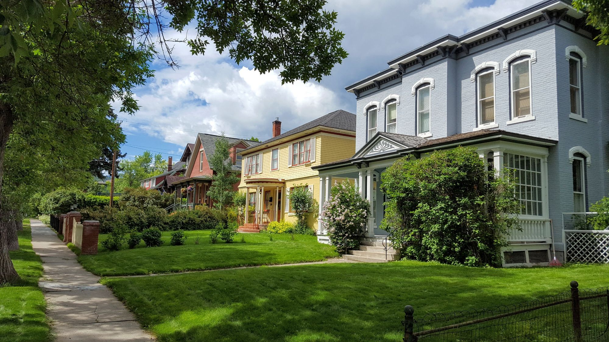 Tree-lined residential street with historic homes in Helena, Montana