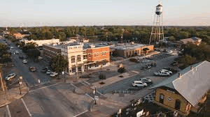 Downtown Kyle, Texas featuring historic buildings, a water tower, and a Central Texas streetscape