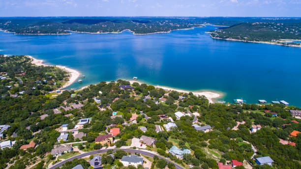 Aerial view of Lakeway, Texas overlooking Lake Travis with waterfront homes, rolling Hill Country terrain, and expansive blue water.