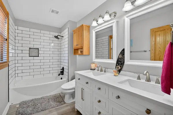 An updated bathroom features a bright white finish