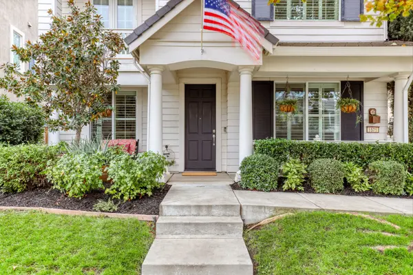 Exterior of home with white framing and black door