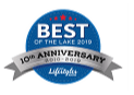 Round blue award badge with a grey ribbon banner on the bottom and 'Best' style mark in the center, vertical orientation, decorative stars at top.