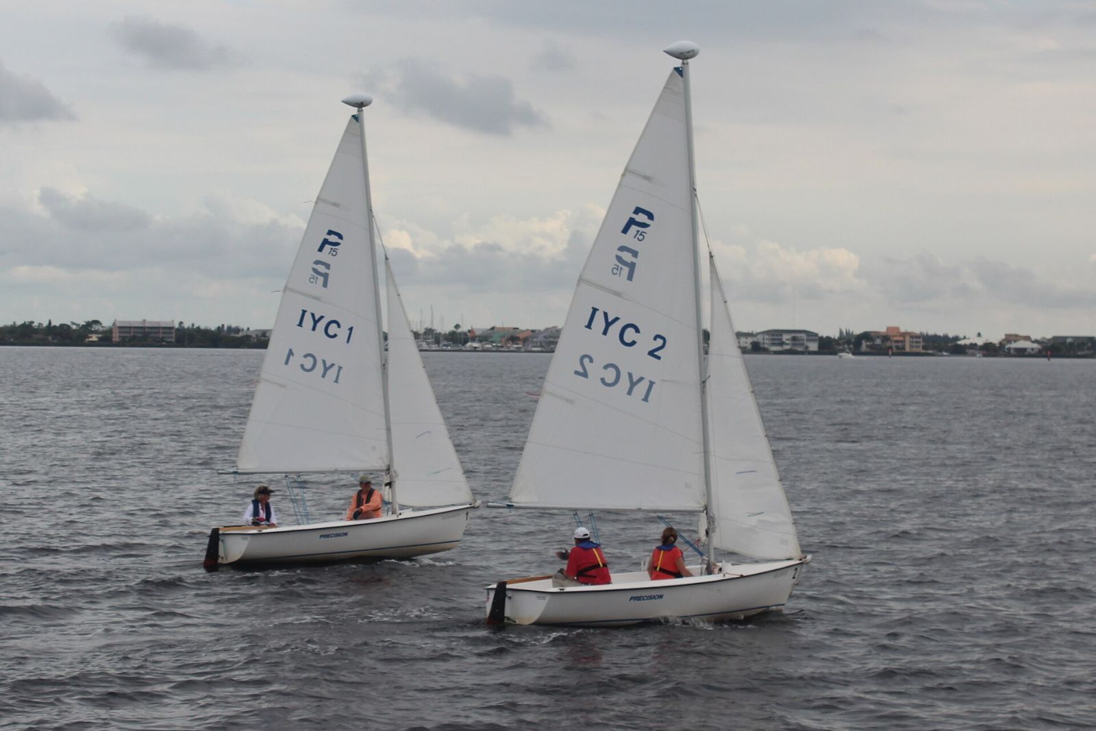 Two small sailboats racing on Charlotte Harbor