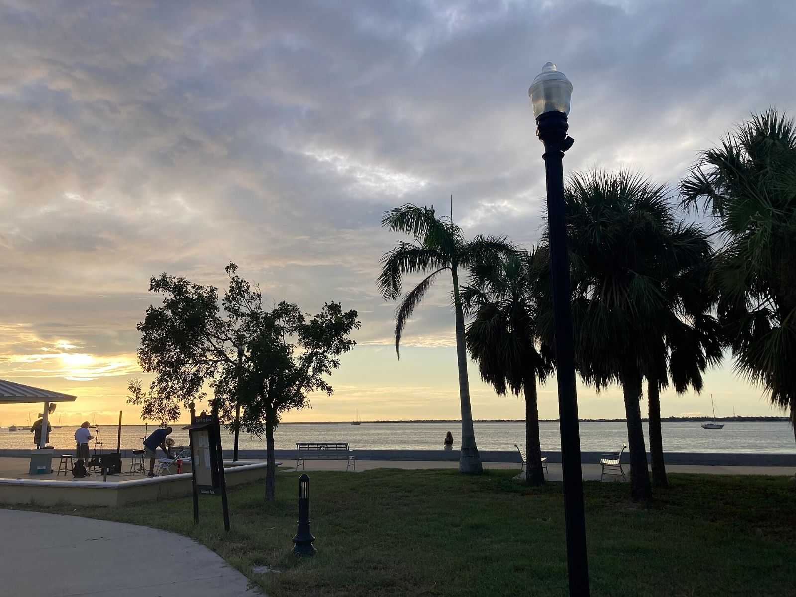 Palm trees and a lamppost at Gilchrist Park on the Punta Gorda waterfront at sunset