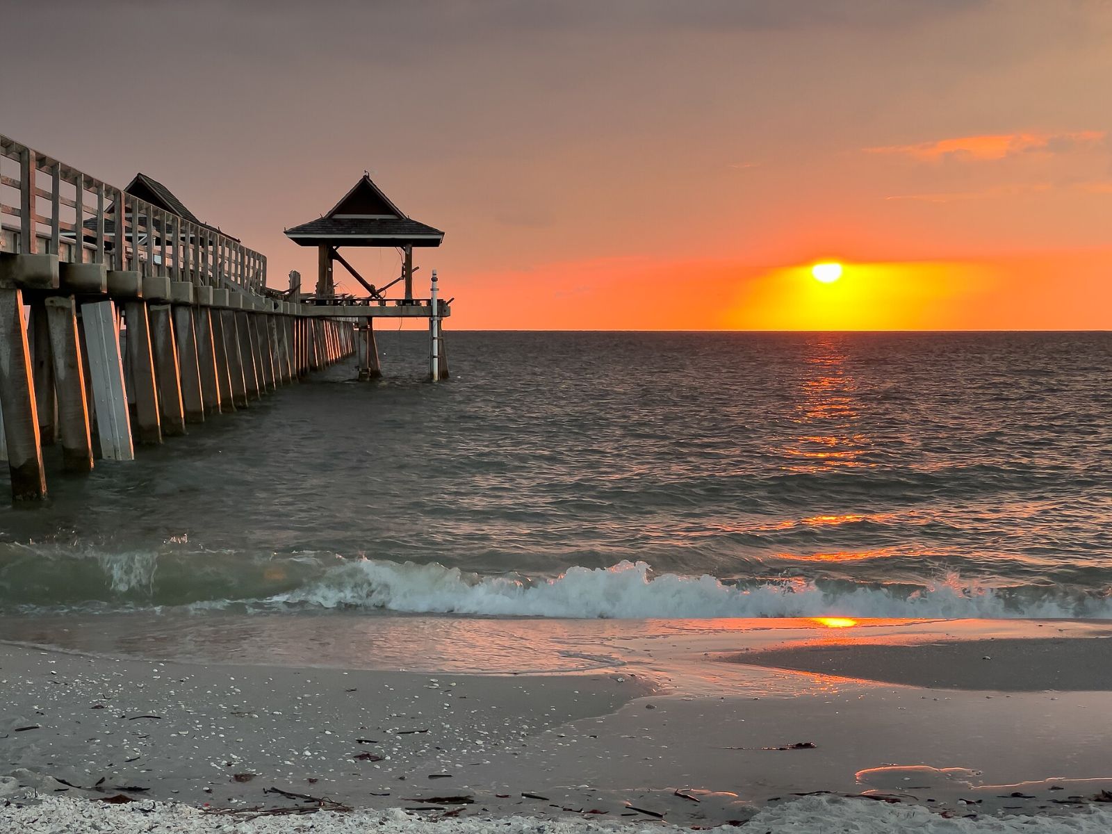 The Naples Pier at sunset over the Gulf of Mexico in March 2023
