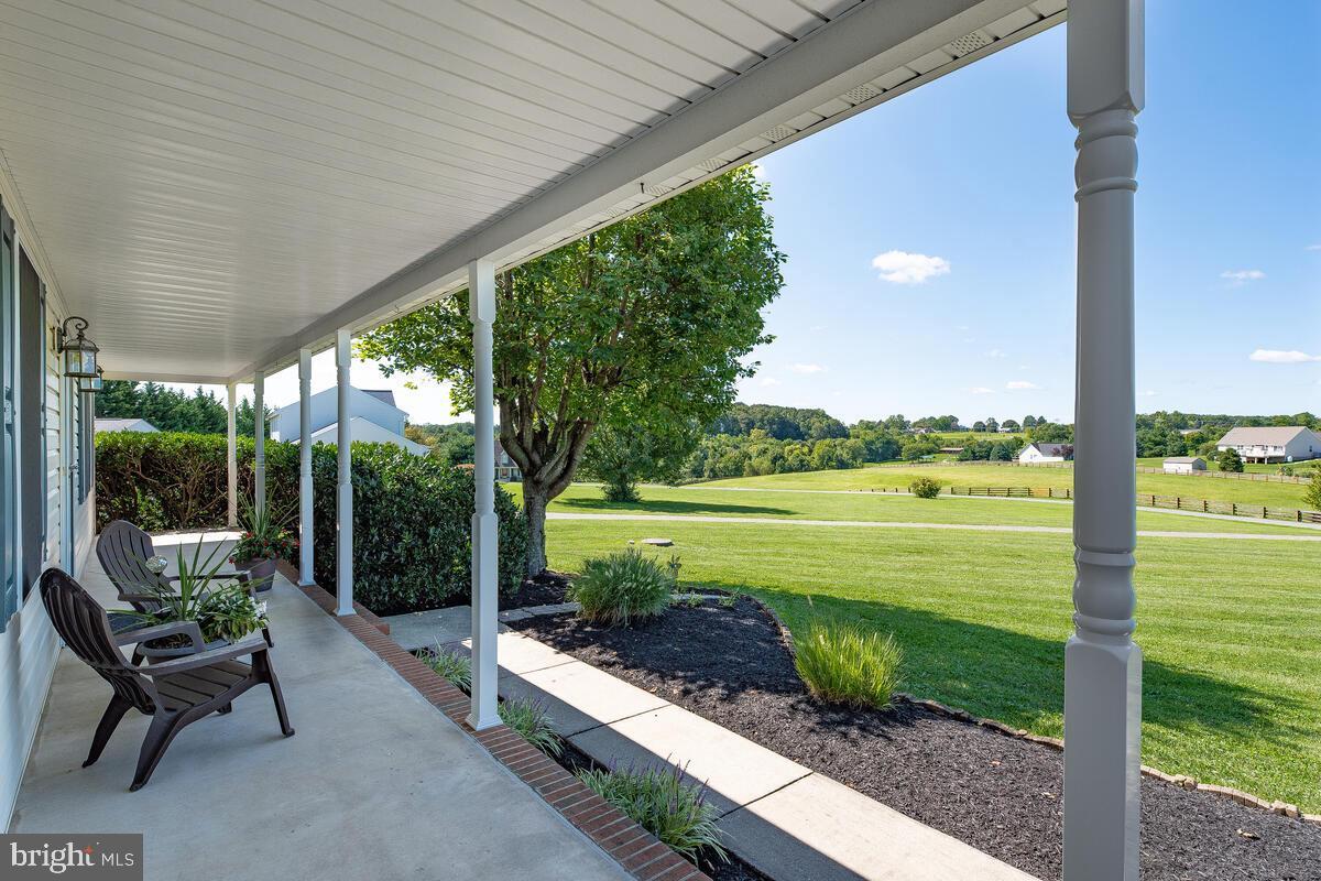 Covered porch overlooking open green space in Westminster