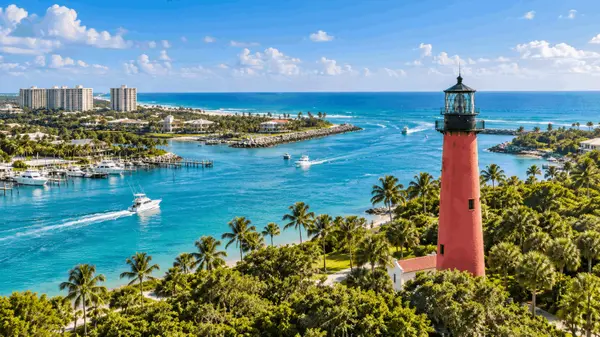 Aerial view of Jupiter Inlet Lighthouse, turquoise waterways and Atlantic coastline in Jupiter, Florida