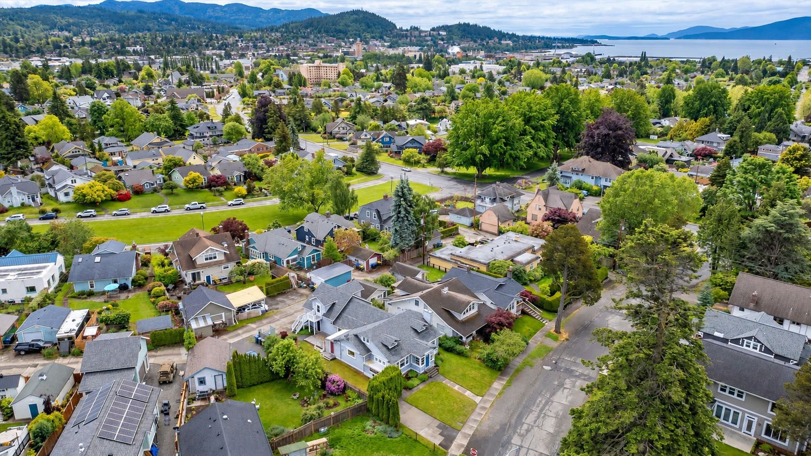 Aerial over Bellingham neighborhoods toward downtown, Bellingham Bay and Lummi Island.