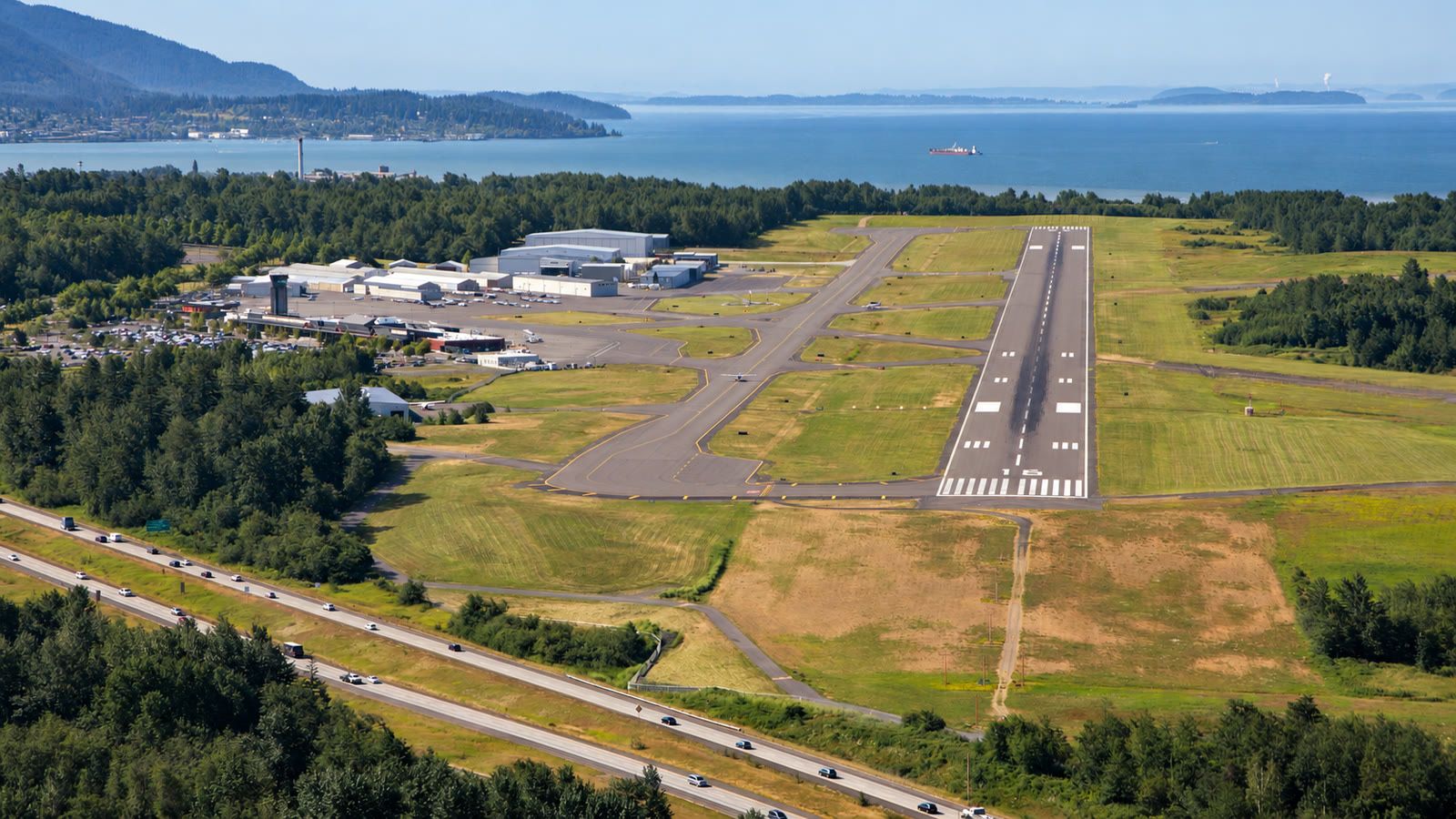 Aerial of the Bellingham International Airport runway, with Bellingham Bay and the islands beyond.