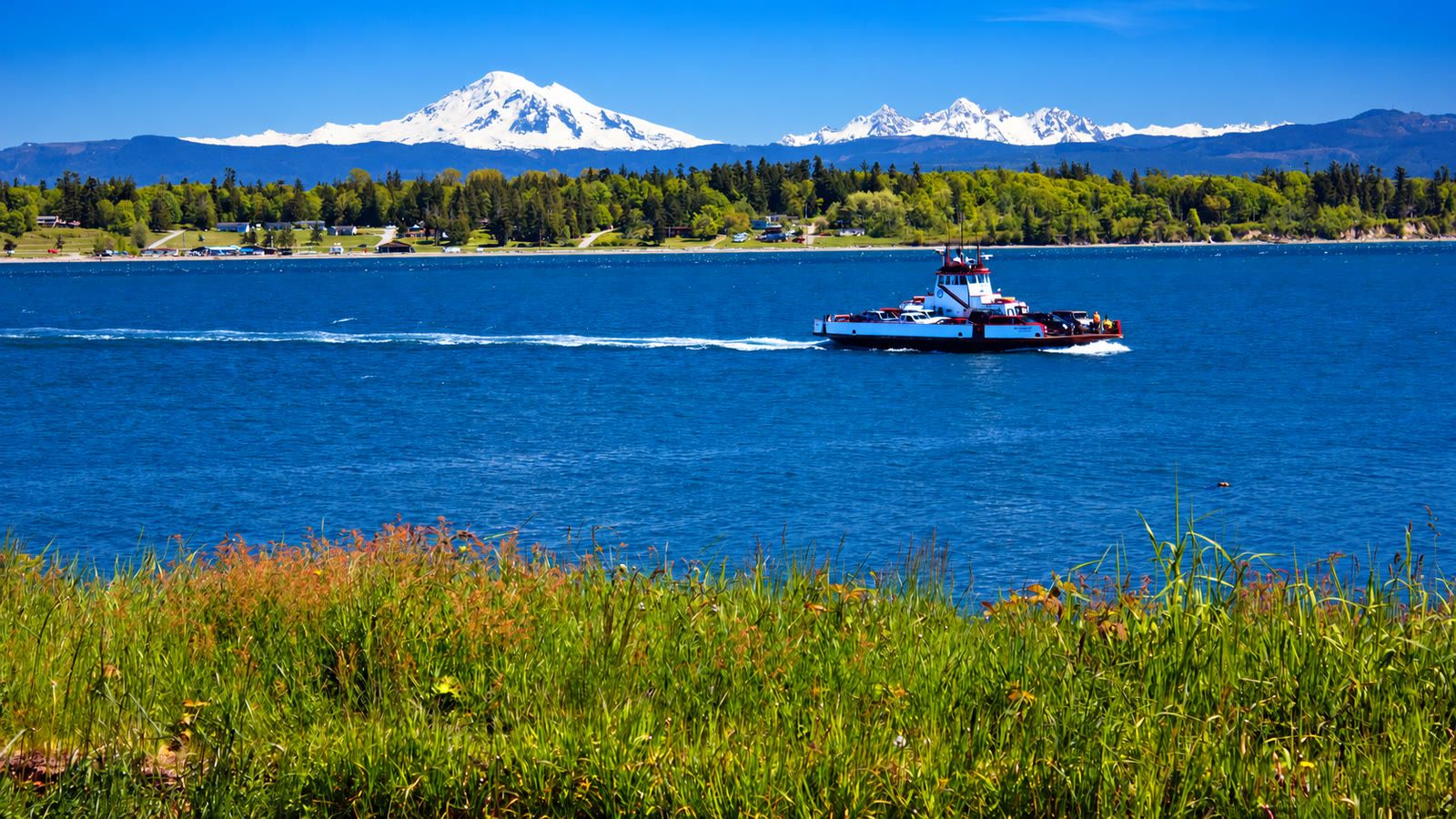 The Lummi Island ferry Whatcom Chief crossing Hale Passage below Mt. Baker and the Twin Sisters.