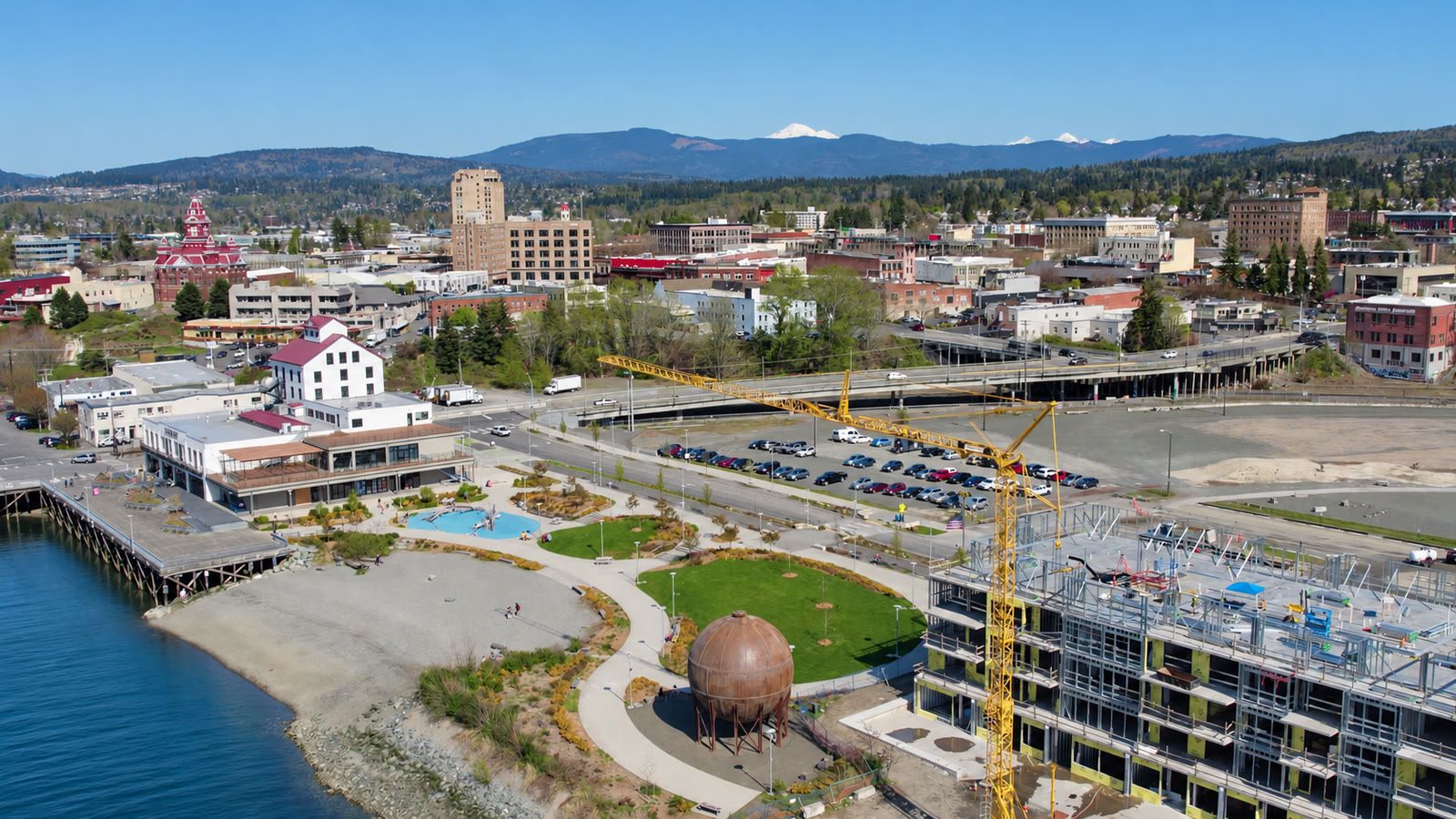 Aerial of Waypoint Park and the Granary Building on the Bellingham waterfront, with new construction and downtown behind.