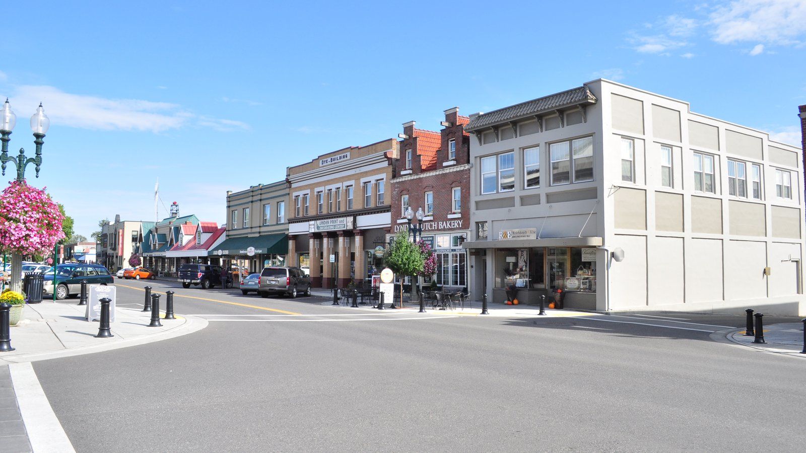 Front Street in downtown Lynden, with historic brick storefronts, hanging flower baskets and a Dutch-style stepped gable.