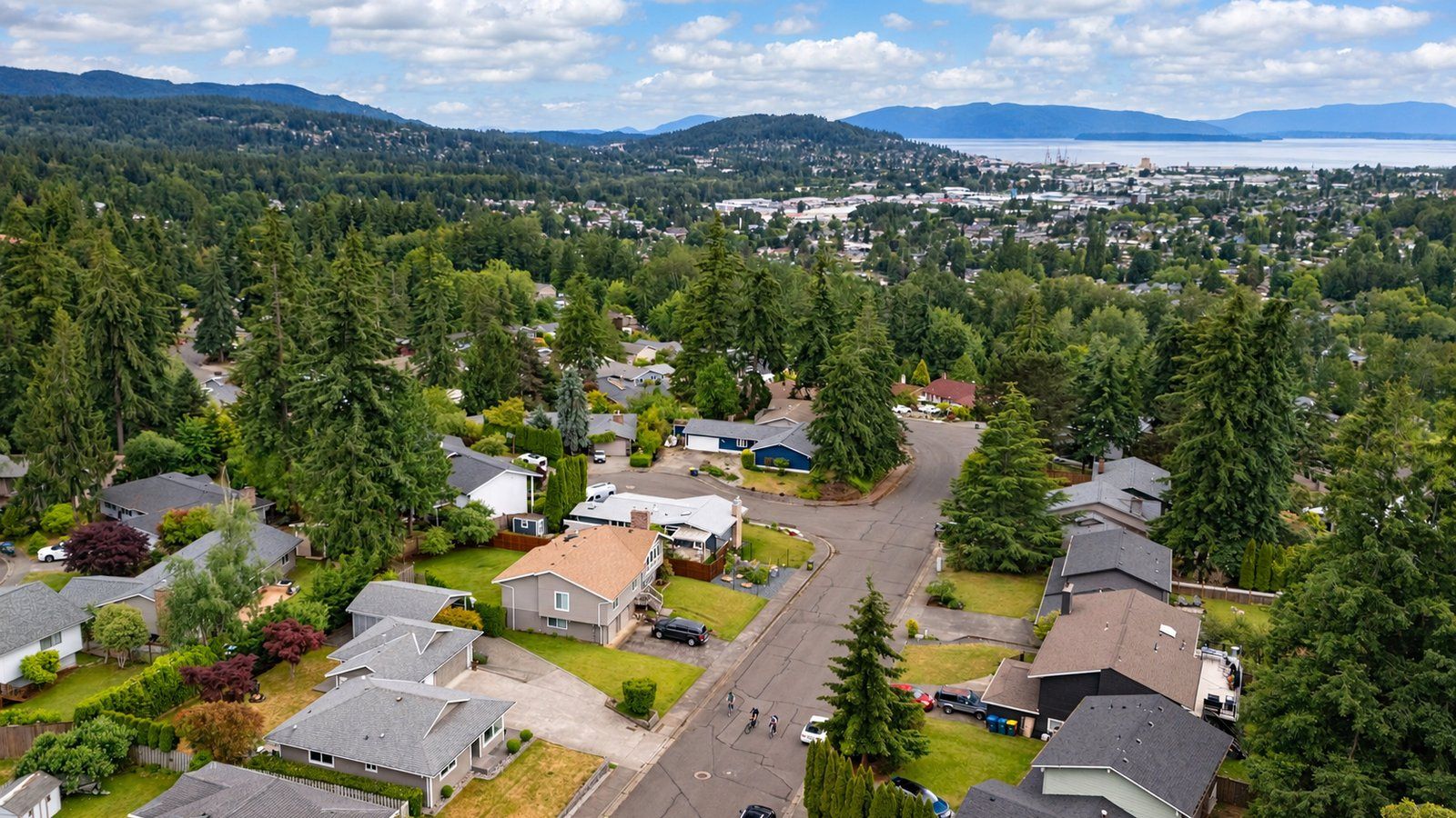 Aerial view of single-family homes in Bellingham's Samish neighborhood, with Bellingham Bay in the distance.