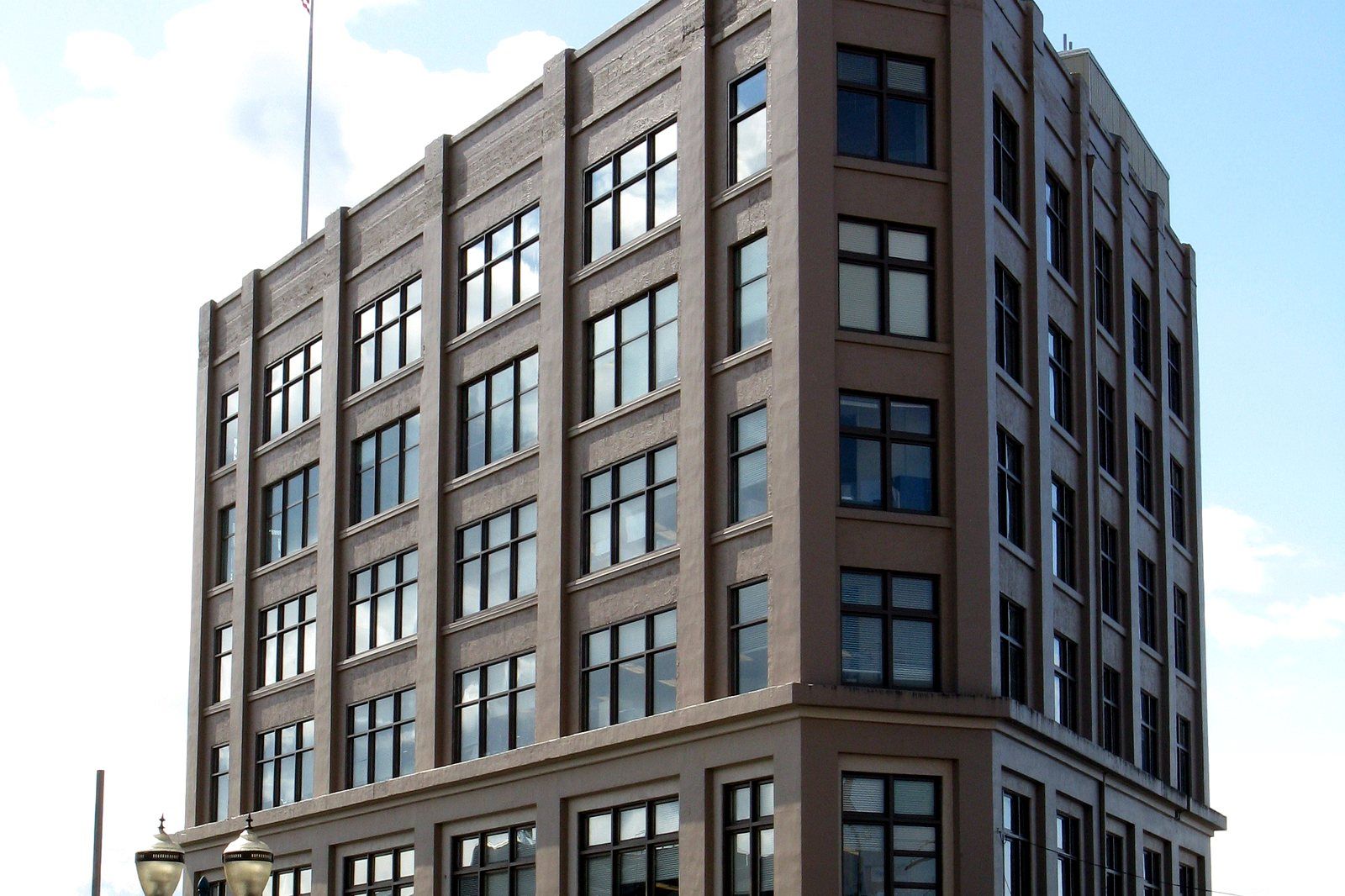 A converted early-1900s brick building housing lofts and shops along a Downtown Bellingham, WA street